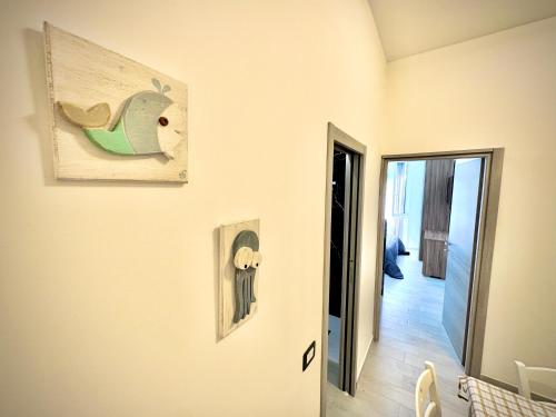 a hallway with a painting of a bird on the wall at Santa Marinella Homes in Santa Marinella
