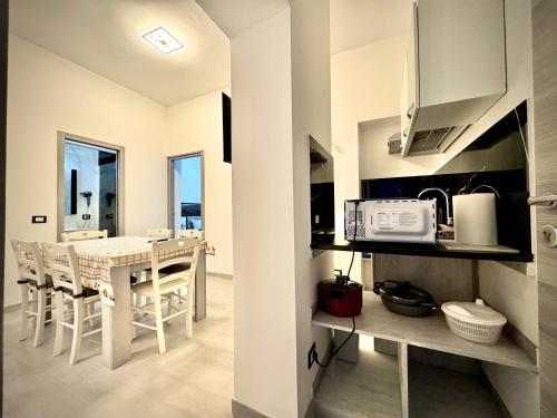 a kitchen and dining room with a table and chairs at Santa Marinella Homes in Santa Marinella
