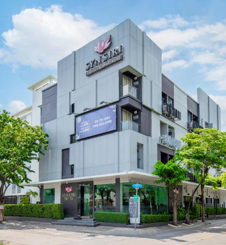 a large white building with a sign on it at Synsiri Ladprao 130 in Ban Bang Toei (1)