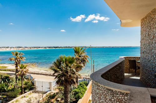 a balcony with a view of the ocean at Hotel Alba in Torre Lapillo