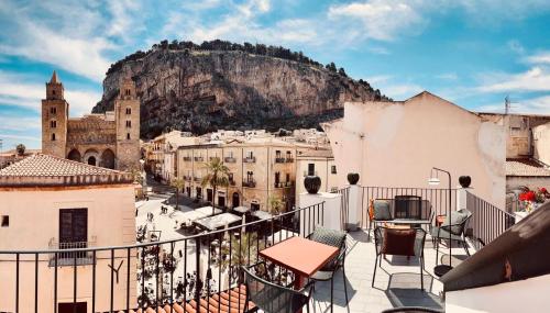 a view of a city with a mountain in the background at Palazzo Villelmi in Cefalù