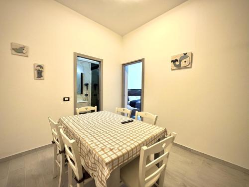 a dining room with a table and chairs and a window at Santa Marinella Homes in Santa Marinella