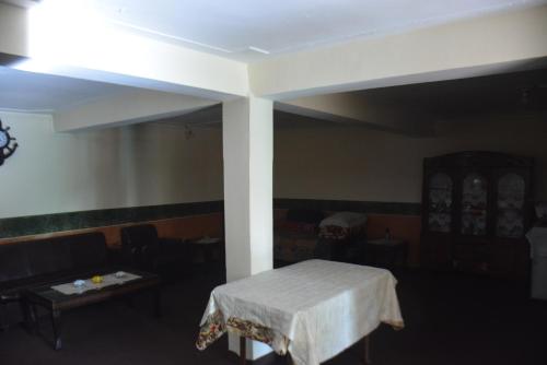 a room with a table and a white table cloth at Riasat Home Stay - Nathia Gali Road in Bāzār