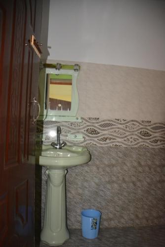 a bathroom with a sink and a mirror at Riasat Home Stay - Nathia Gali Road in Bāzār