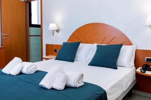 a hotel room with a bed with towels on it at Hotel Alba in Torre Lapillo