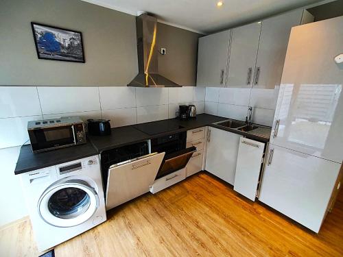a kitchen with a washing machine and a washer at Stadt Apartments Solingen in Solingen