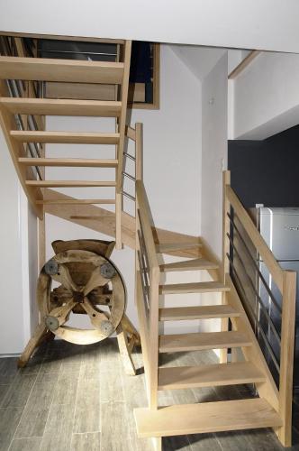 a set of stairs in a room with a table at les gîtes de la cuesta in Henneveux