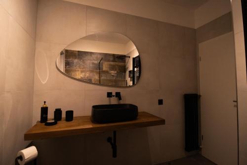 a bathroom with a sink and a mirror at Veralto - Modern Suite with Como Lake view in Vacallo