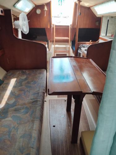a table and bench in the back of a boat at Cavallino House Boat in Cavallino-Treporti