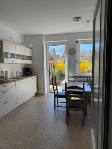 a kitchen and dining room with a table and chairs at Historie trifft Moderne in Weikersheim