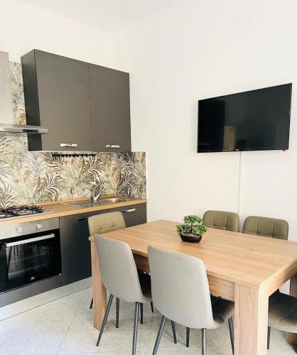 a dining room with a wooden table and chairs at GioGio house in Vico Equense