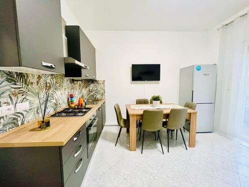a kitchen with a table and a dining room at GioGio house in Vico Equense