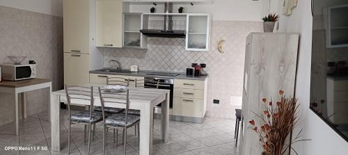 a kitchen with a table and chairs in a kitchen at Casa DàCà in Marrùbiu