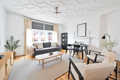 a living room with a couch and a table at Huge 2 Bedrooms 3 Beds! Covent GDN 3 min to subway in London