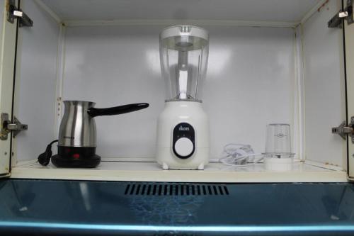 a blender sitting on a shelf in a kitchen at Ajman for families in Ajman 