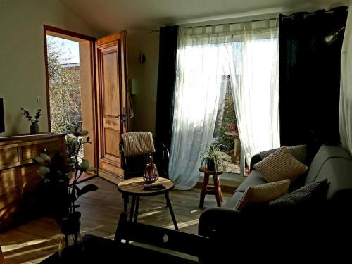 un salon avec un canapé et une table dans l'établissement Aux portes de l'Ardèche et des Cévennes, à Allegre Les Fumades