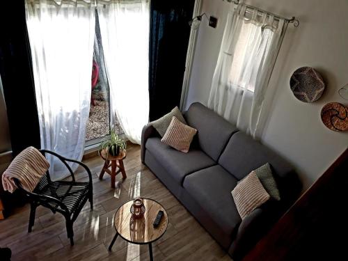 un salon avec un canapé et une table dans l'établissement Aux portes de l'Ardèche et des Cévennes, à Allegre Les Fumades