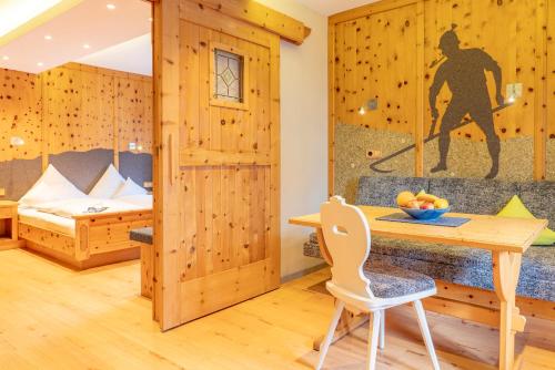 a room with wooden walls and a desk and a bed at Ferienwohnung Ferienglück in Krün