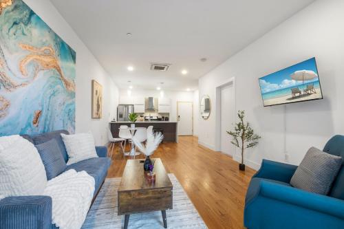 a living room with a couch and a table at Chic 1BR Retreat - Pool, Gym Balcony Views in Philadelphia