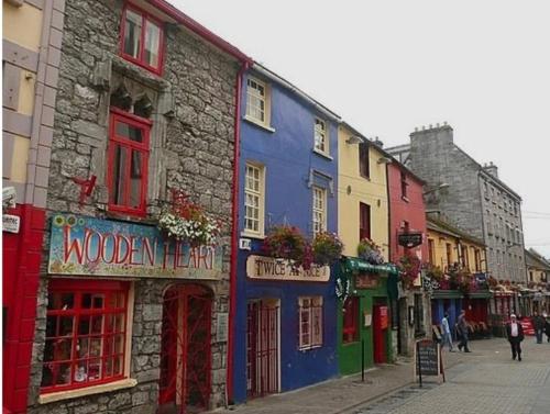 a row of colorful buildings on a city street at Tigh na Mara, Brand New Semi-Detached House, Furbo in Furbo