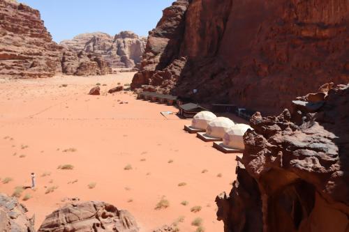 a view of a desert with rocks and a mountain at Wadi rum Bubble Camp & tour in Wadi Rum
