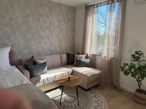 a living room with a couch and a table at Boutique Studio Apartment Lucca - Parkplatz - Bahnhof in Osnabrück