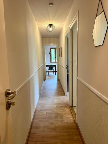 an empty hallway with a door and a table at Le Charme du Perigord - chambre & table d'hotes in Saint-Sulpice-dʼExcideuil