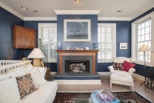 a living room with blue walls and a fireplace at Coastal Casa home in Atlantic Beach