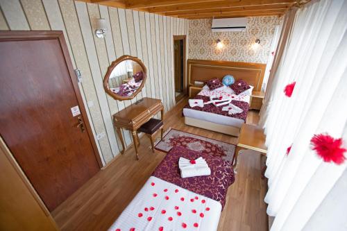 a bedroom with a bed and a dresser at Sirkeci Emek Hotel in Istanbul