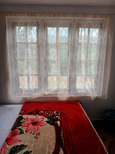 Postel nebo postele na pokoji v ubytování Lalitaly Lodge