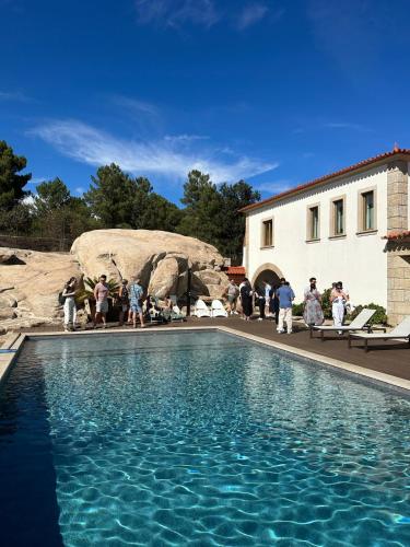a group of people standing around a swimming pool at Royal Fraga do Douro in Vila Real
