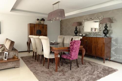 a dining room with a table and chairs and a mirror at Royal Fraga do Douro in Vila Real
