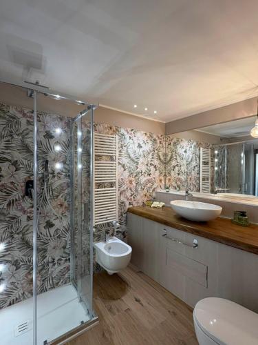 a bathroom with two sinks and a shower at Corso Italia 111 guest house in Viterbo