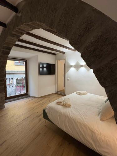a bedroom with a large bed and a large window at Corso Italia 111 guest house in Viterbo