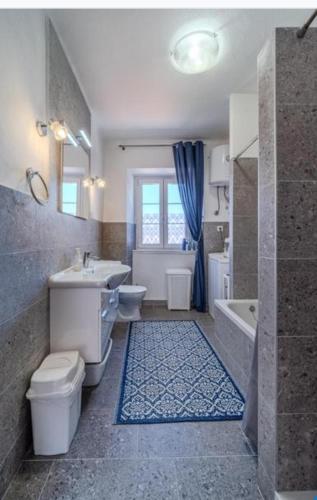 a bathroom with a toilet and a sink and a tub at Bunica house in Nerežišće