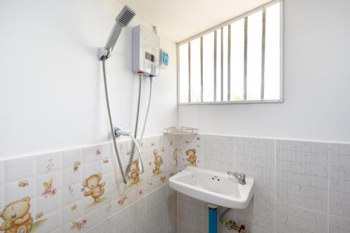 a bathroom with a sink and a shower at Narucha Farmstay in Ban Chuk Yai Yuan