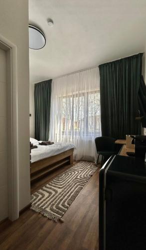 a bedroom with a bed and a large window at VilaVala in Nymburk
