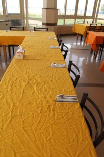 a row of tables with forks and knives on them at بيت الشباب الاسماعيلية in Ismailia