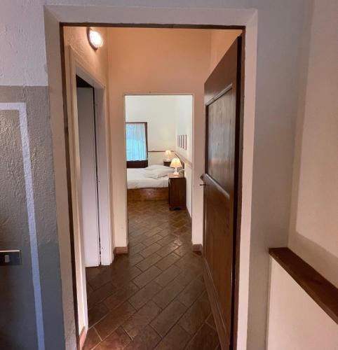 a hallway with a room with a bed and a mirror at Country House Le Case Coloniche in Deruta