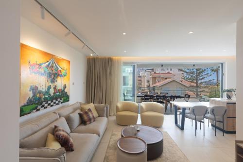 a living room with a couch and a table at Mackenzy Dream Residence 202 in Larnaca