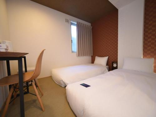 Postel nebo postele na pokoji v ubytování HOTEL WAN OSAKA EBISU