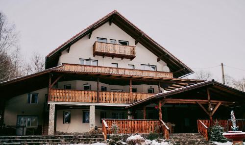 a large house with wooden balconies on it at Villa Yajima in Predeluţ