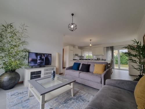 a living room with a couch and a table at Madureira Country House - Natureza & Tranquilidade in Paradela de Guiães