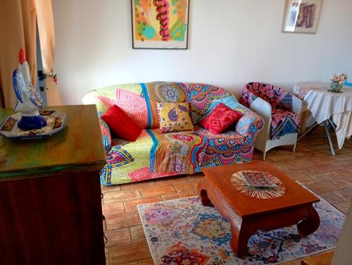 a living room with a couch and a table at Bohème Valdareina, Piscine chauffée, Bénagil-Carvoeiro in Carvoeiro