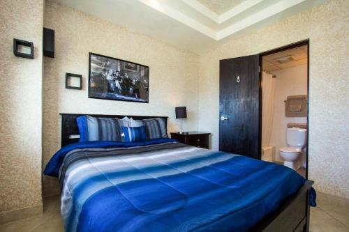 a bedroom with a large blue bed in a room at Louis Vistas de San Juan in San Juan