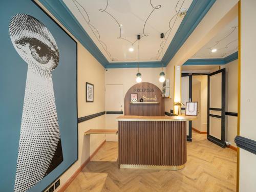 a bar in a room with a painting on the wall at Hotel Boronali - Nouvellement rénové in Paris