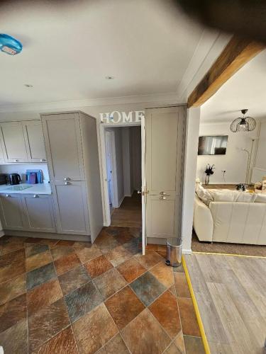 a living room with a home sign on the wall at Greenways at Coed Cae Farm in Pontnewydd