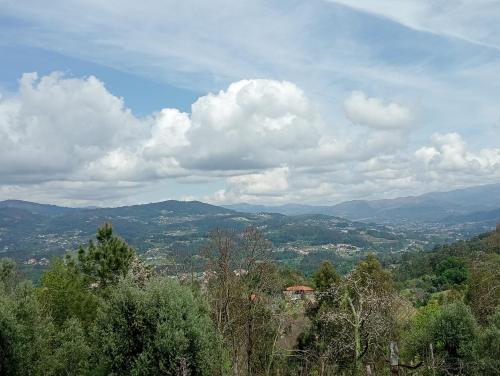 a view of a valley with mountains and clouds at Casa Coruja in Ponte da Barca
