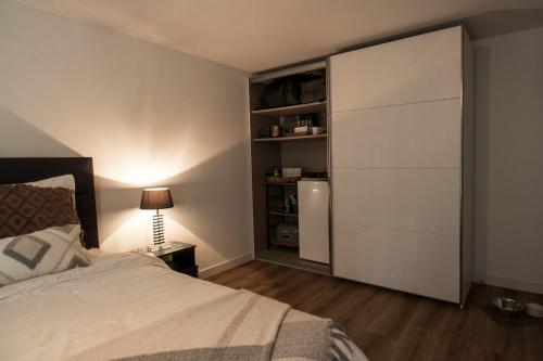 a bedroom with a bed and a large white closet at Mawosy Lodge in Apeldoorn