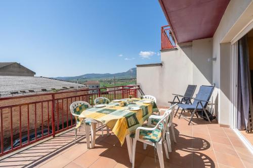 a table and chairs on a balcony with a view at Ca l'Agnès in Oliana